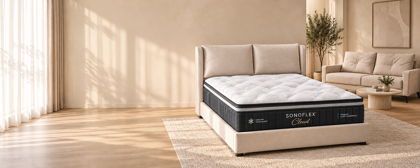 SonoFlex Cloud mattress on a SonoFrame Aurora bed frame, with a SonoLounge Cove sofa, in a bright studio apartment